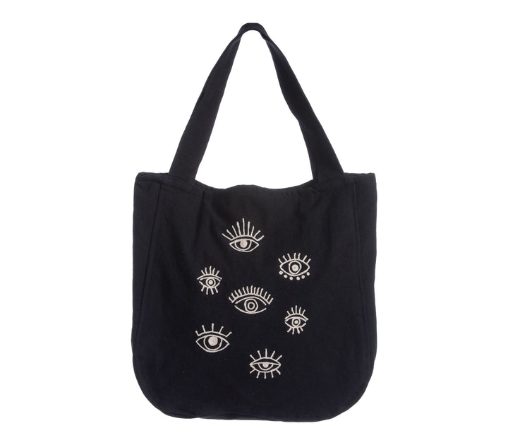 Μαύρη τσάντα θαλάσσης με φαρδιά χερούλια ώμου και σχέδιο με μάτια στο μπροστινό μέρος, τοποθετημένη σε λευκό φόντο.