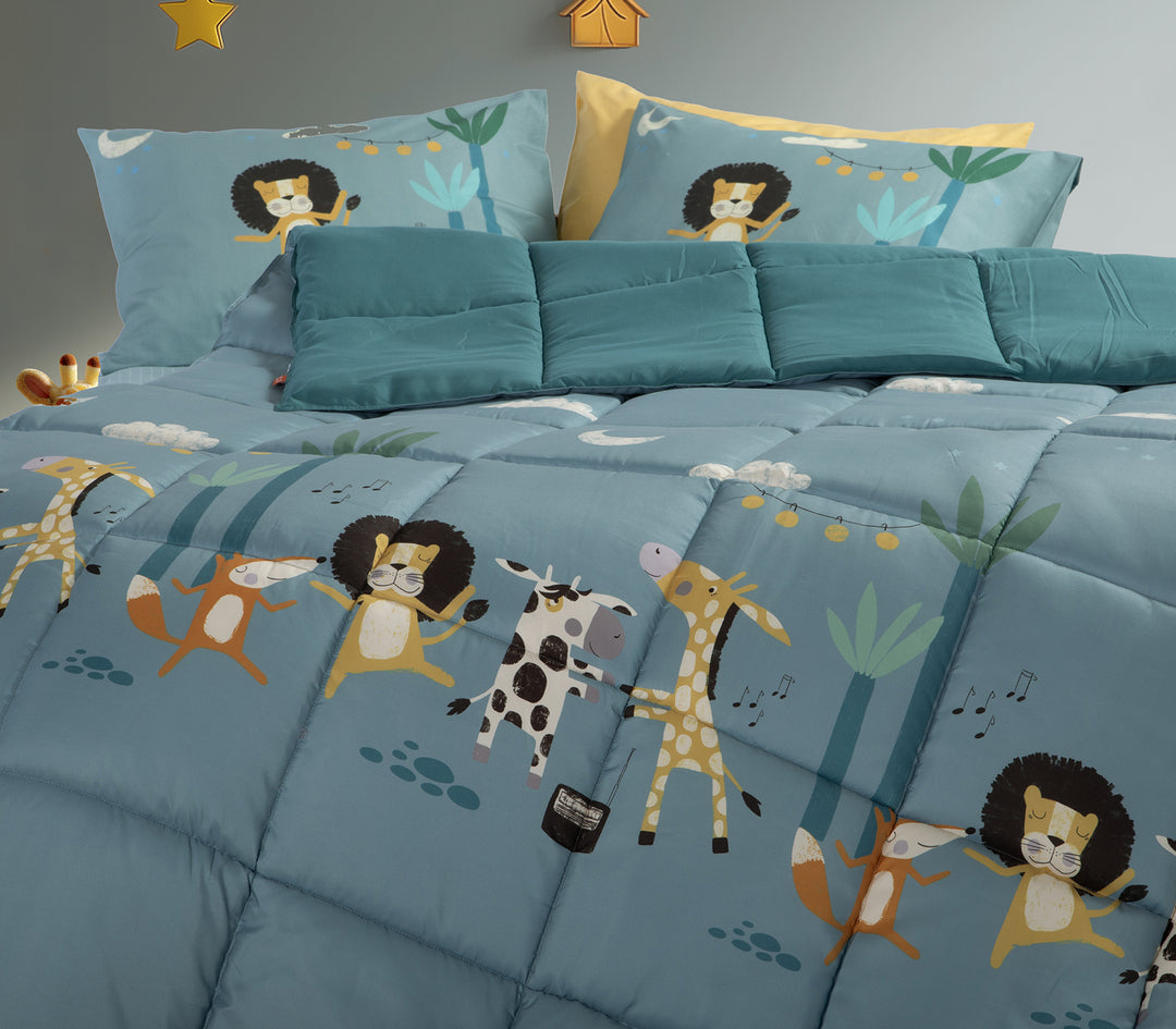 Κοντινή λήψη παιδικού παπλώματος σε γαλάζιο χρώμα, διακοσμημένο με ζωάκια όπως λιοντάρι, καμηλοπάρδαλη, αγελάδα και αλεπού, με πράσινα διακοσμητικά μαξιλάρια και μαξιλαροθήκες στο ίδιο μοτίβο