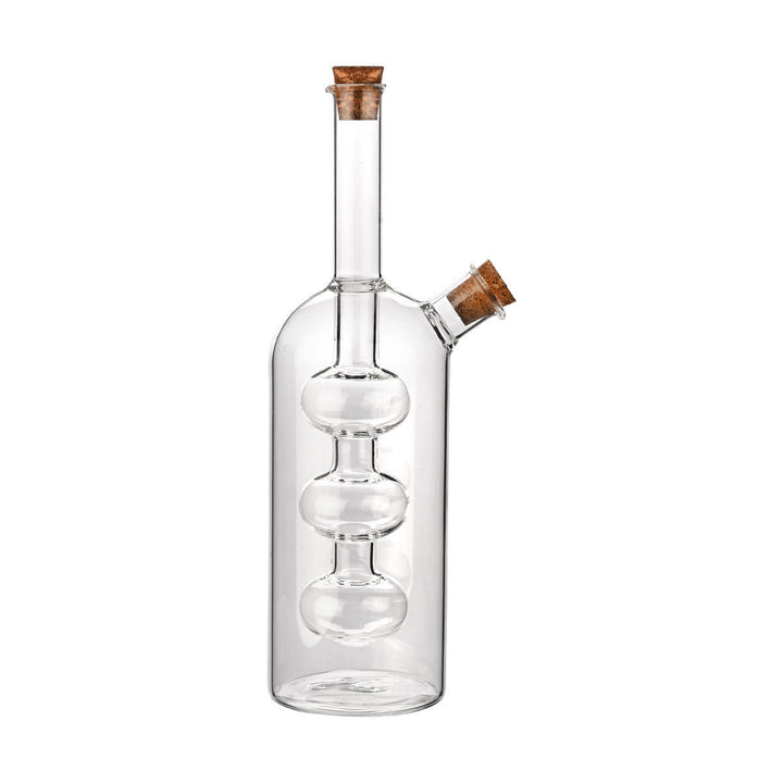 Διάφανη γυάλινη φιάλη λαδιού με τριπλό εσωτερικό δοχείο και πώμα φελλού, σε λευκό φόντο.