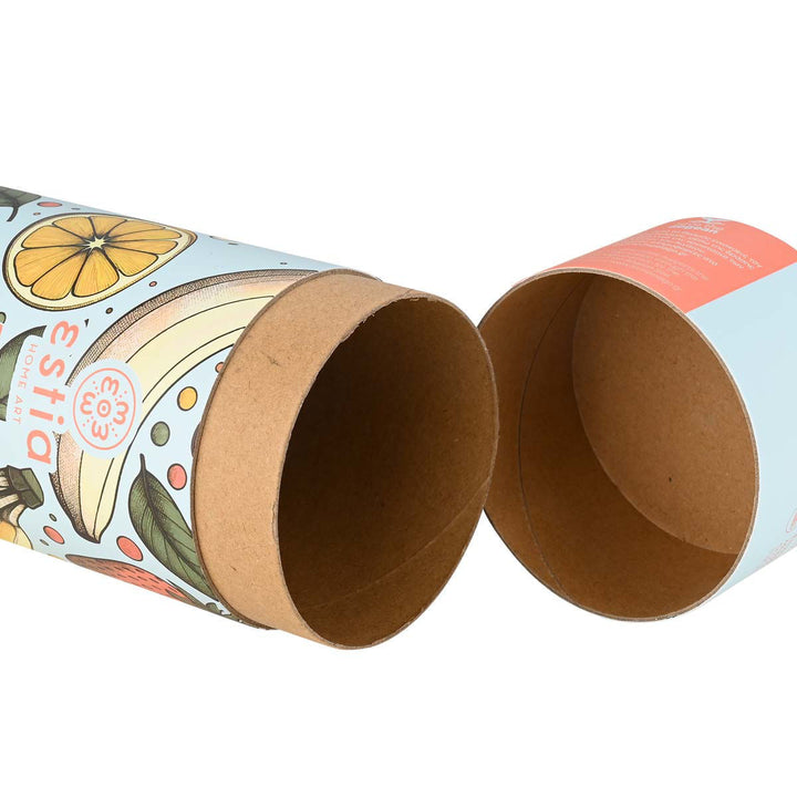 Κυλινδρική συσκευασία Estia Home Art Banana Swirl ανοιχτή, με έντονα τροπικά φρούτα πάνω σε γαλάζιο φόντο και eco-χαρτόνι εσωτερικά.