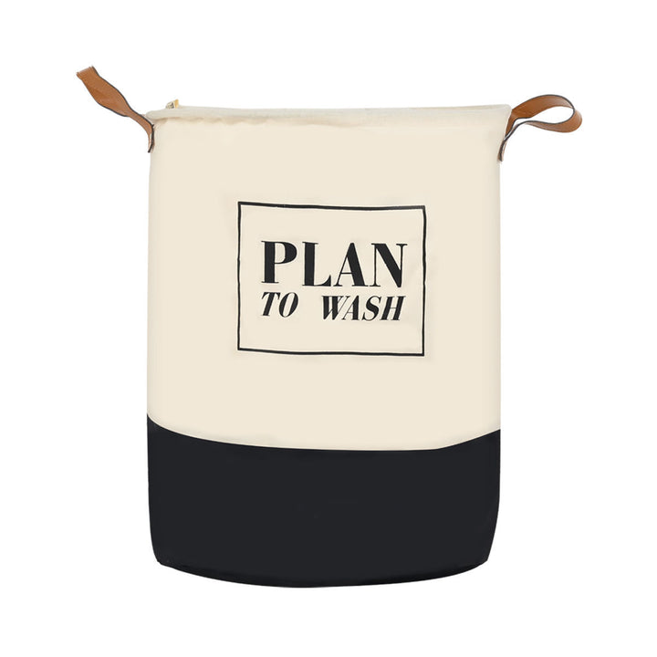 Καλάθι απλύτων Estia Plan σε εκρού και μαύρο χρώμα με γραφή “Plan to Wash” και χερούλια, τοποθετημένο σε φωτεινό χώρο.