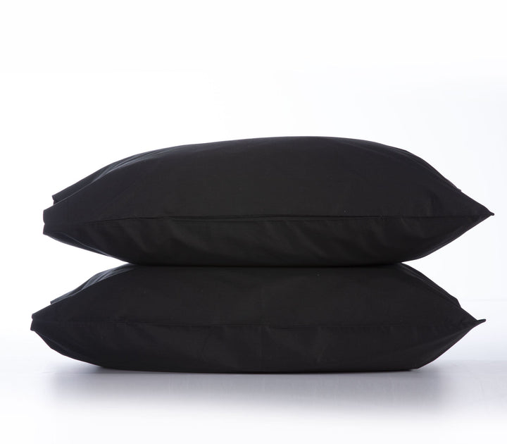 Δύο μαξιλαροθήκες σε μαύρο χρώμα, τοποθετημένες η μία πάνω στην άλλη, σε φωτεινό λευκό φόντο που αναδεικνύει την έντονη και κομψή απόχρωση, ιδανικές για μοντέρνα και σοφιστικέ αισθητική