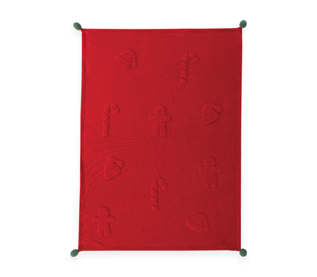 Κόκκινη χριστουγεννιάτικη fleece κουβέρτα με ανάγλυφα σχέδια gingerbread, ζαχαρωτά και σκούφο Άγιου Βασίλη, διακοσμημένη με πράσινες φουντίτσες στις γωνίες