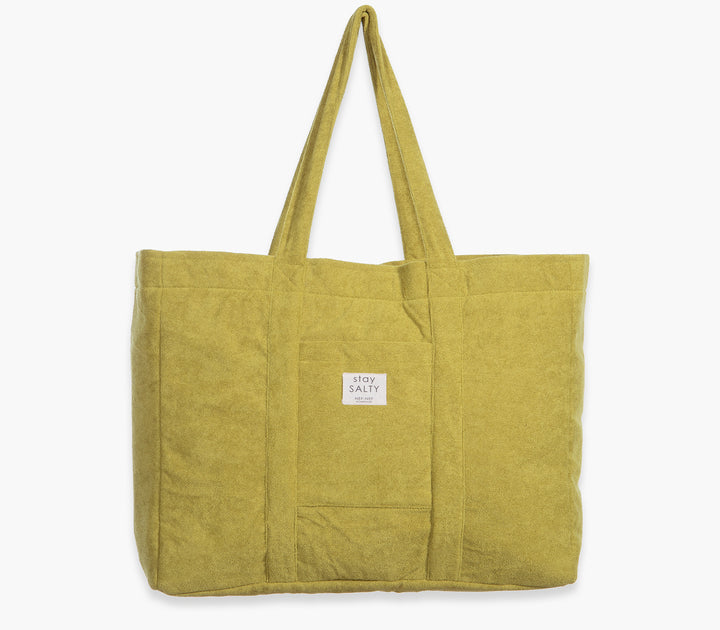 Λαχανί τσάντα θαλάσσης μονόχρωμη με υφασμάτινες λαβές και εξωτερική τσέπη σε λευκό φόντο.