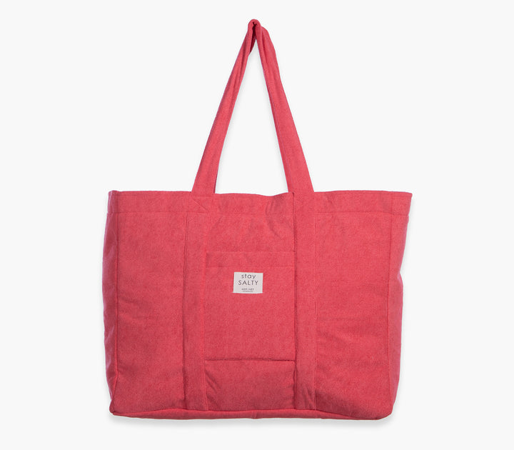 Κοραλί τσάντα θαλάσσης μονόχρωμη με υφασμάτινες λαβές και εξωτερική τσέπη σε λευκό φόντο.