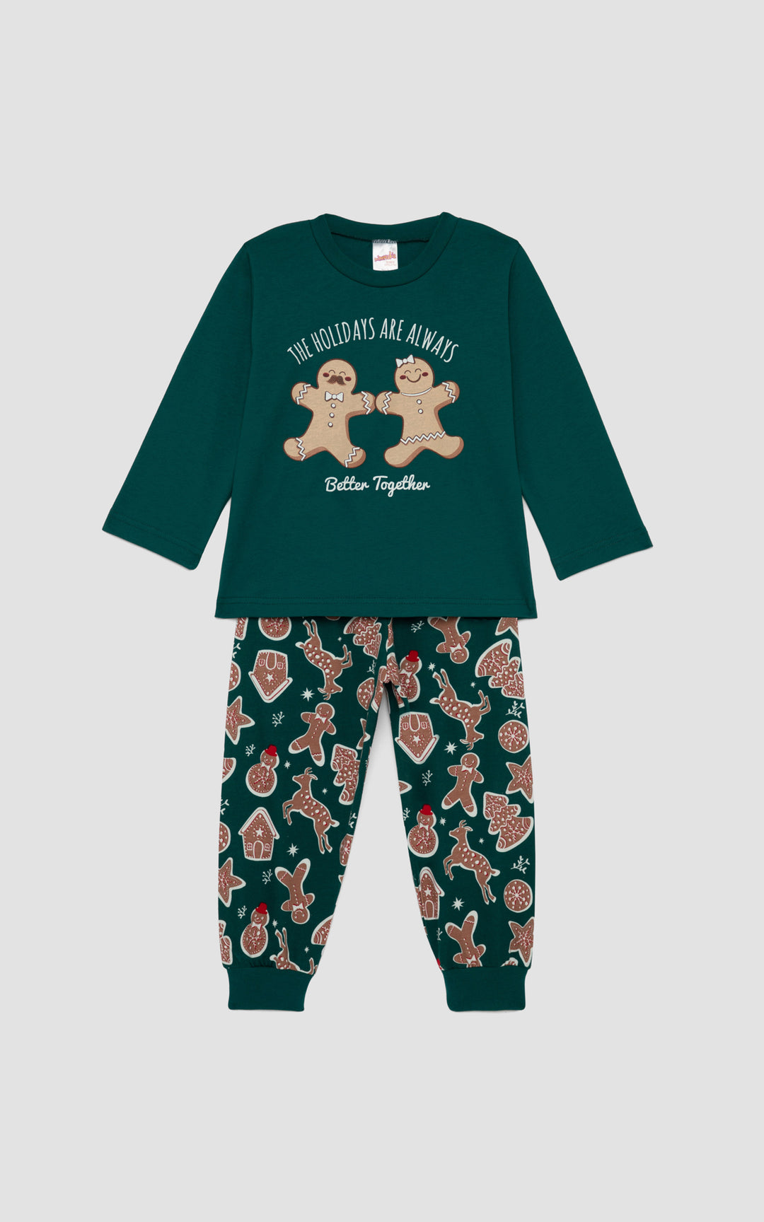 Πράσινη βρεφική πιτζάμα με χριστουγεννιάτικό ύφος και σχέδια από χαρούμενα μπισκοτάκια, μπροστά από απαλό γκρι φόντο. 