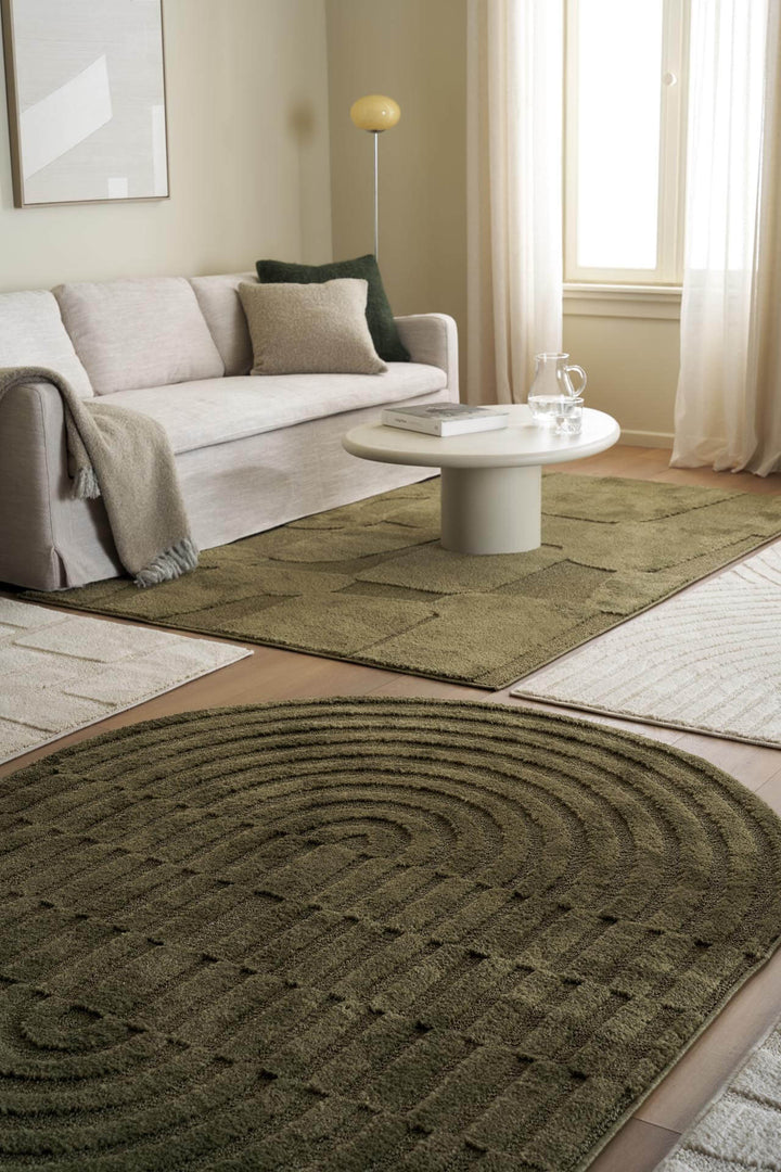 Οβάλ χαλί Jazz της Royal Carpet σε λαδί, τοποθετημένο σε διαμορφωμένο χώρο, με προσεγμένο σχέδιο της σειράς και εμφανή υφή επιφάνειας.