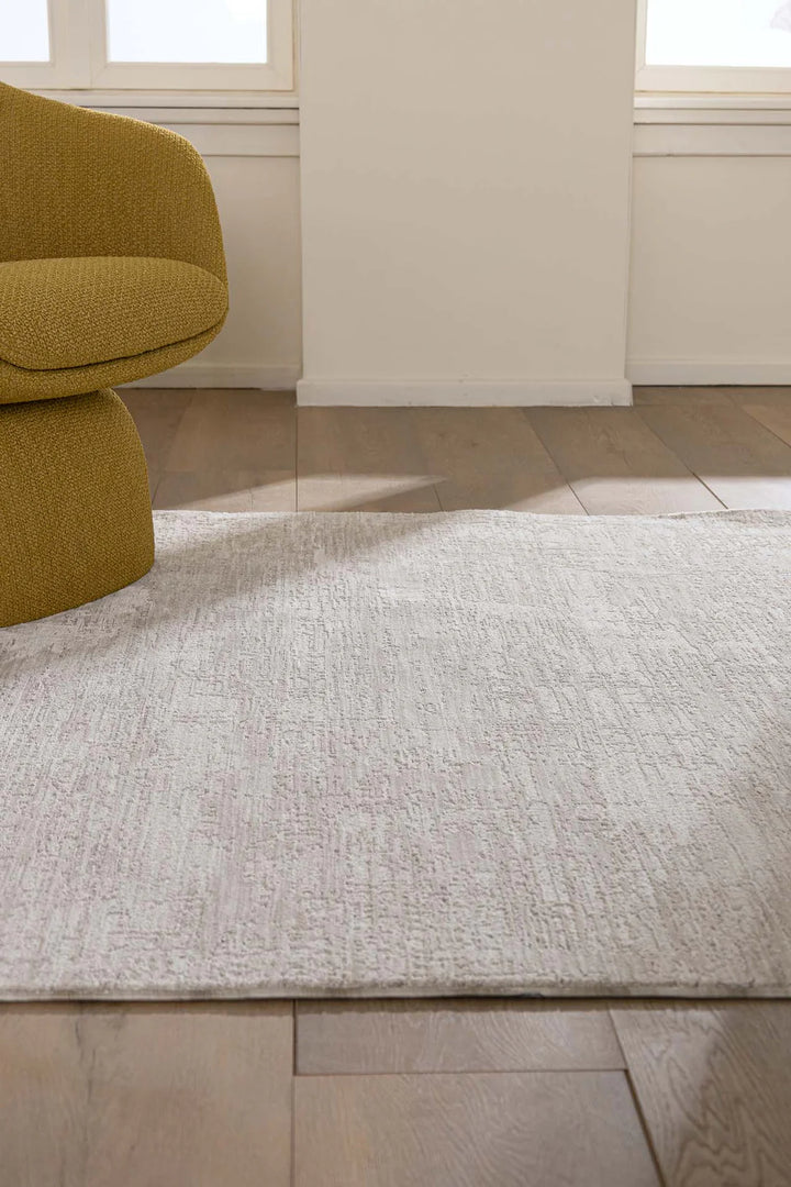 Μοντέρνο λευκό χαλί Prime Royal Carpet σε φωτεινό καθιστικό με ώχρα πολυθρόνα και ξύλινο πάτωμα.